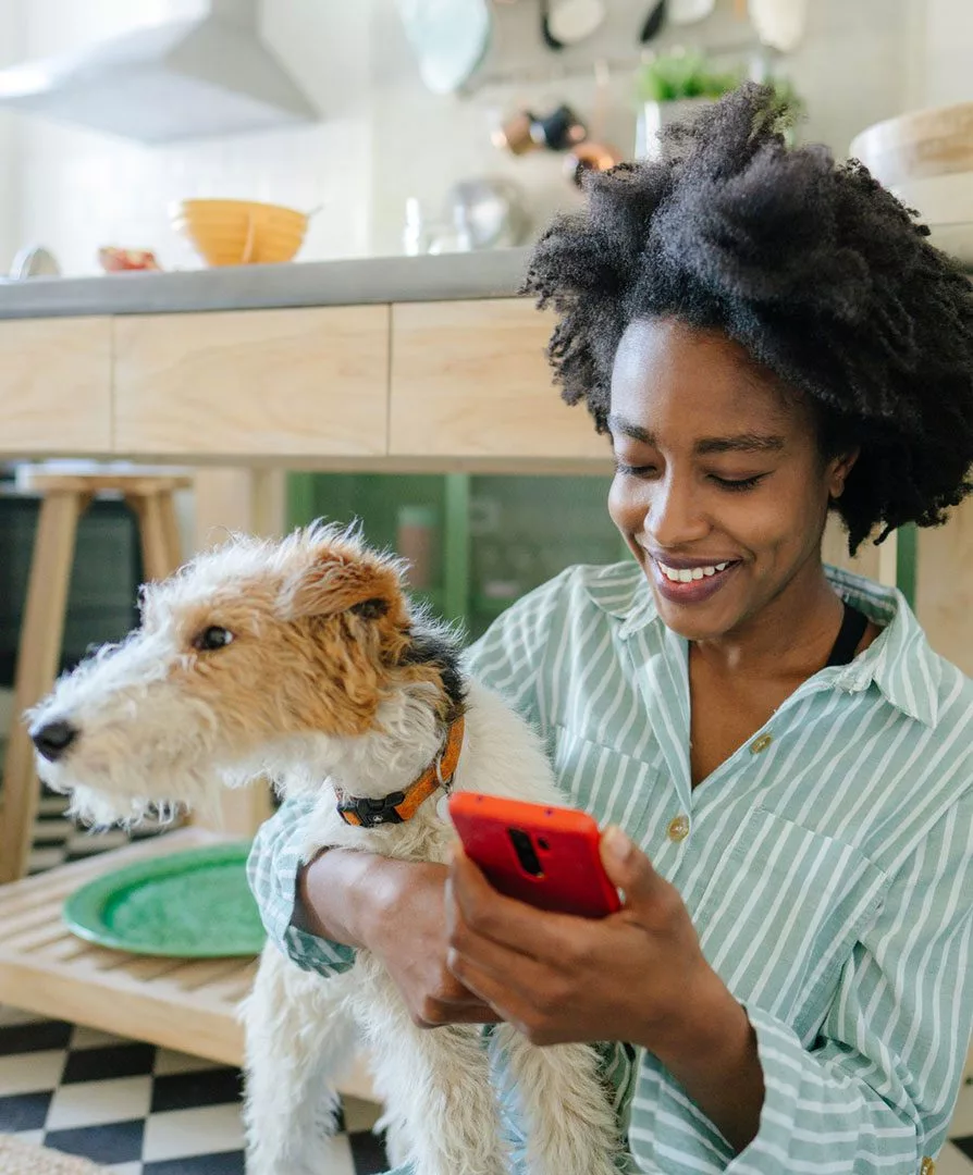 Pet owner on phone with dog